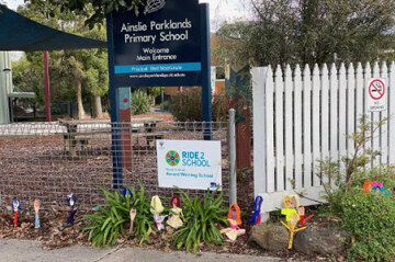 Ainslie Parklands Primary School with decorated wooden spoons at the front gate