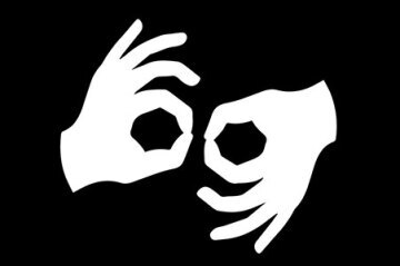 silhouette of white hands on black background making auslan signs